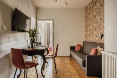 a kitchen with white appliances and wooden cabinets at Grodzka by Tyzenhauz in Kraków