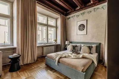 a living room with a couch and a chandelier at Grodzka by Tyzenhauz in Kraków