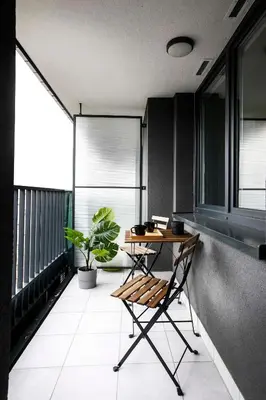 a balcony with a table and a plant on it at Cozy studio next to Cracow Vistula Boulevrads, Old Town in Kraków