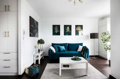 a living room with a blue couch and a table at Cozy studio next to Cracow Vistula Boulevrads, Old Town in Kraków