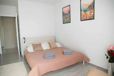 a bedroom with a bed with two towels on it at Pradnicka Local Apartment in Kraków