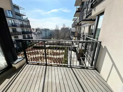 a balcony of a apartment with a view of a yard at Pradnicka Local Apartment in Kraków