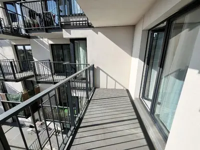 a balcony of a building with stairs and windows at Pradnicka Local Apartment in Kraków