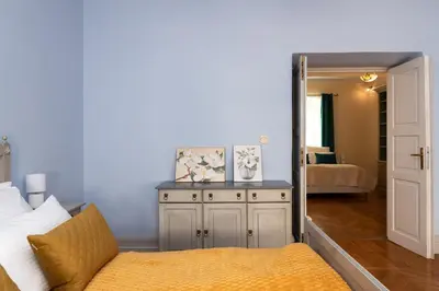 a bedroom with a bed and a large mirror at Kings City - Central Apartment in Kraków