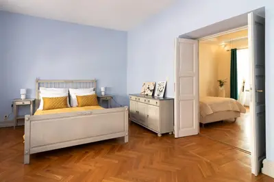 a bedroom with two beds and a mirror at Kings City - Central Apartment in Kraków