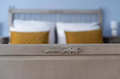 a wooden counter with a flower on the top at Kings City - Central Apartment in Kraków