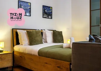 a bedroom with a wooden bed with pillows and a chair at Podzamcze by Tyzenhauz in Kraków
