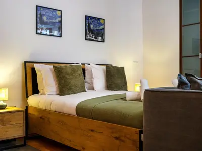 a bedroom with a wooden bed with pillows at Podzamcze by Tyzenhauz in Kraków