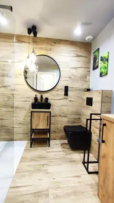 a bathroom with a wooden wall and a mirror at Siesta Forest Apartment Relaxing Park in Kraków