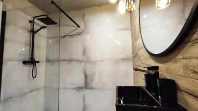 a bathroom with a sink and a mirror at Siesta Forest Apartment Relaxing Park in Kraków