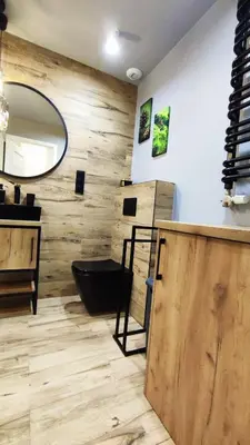 a bathroom with a mirror and a sink and a counter at Siesta Forest Apartment Relaxing Park in Kraków