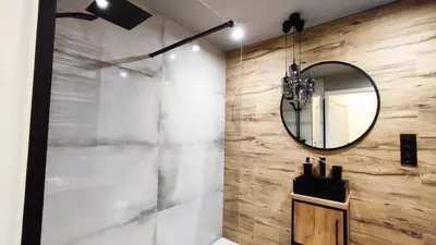 a bathroom with a mirror and a sink at Siesta Forest Apartment Relaxing Park in Kraków