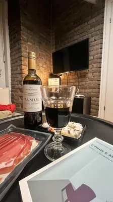 a bottle of wine and a glass on a table at Cracow Fancy Brick #4 - Old Town in Kraków