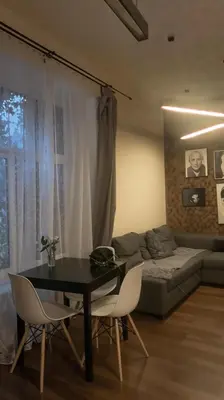 a living room with a table and chairs and a couch at Cracow Fancy Brick #5 - Old Town in Kraków