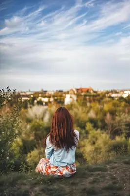 a little girl sitting in a field looking at the horizon at Cracow Fancy Brick #5 - Old Town in Kraków