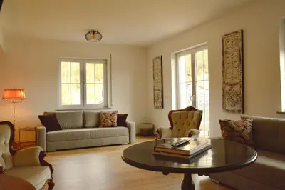 a living room with a couch and a table at Gorczańskie Apartamenty Papiernia - Noclegi w górach Gorce in Niedźwiedź