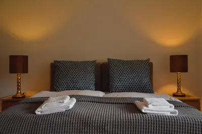 a bedroom with a bed with towels on it at Gorczańskie Apartamenty Papiernia - Noclegi w górach Gorce in Niedźwiedź