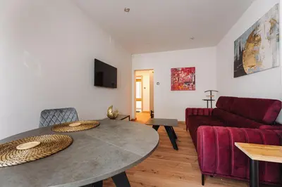 a living room with a table and a couch at Luna Et Sol Apartments in Rząska