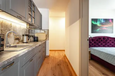 a kitchen with a sink and a bed in a room at Luna Et Sol Apartments in Rząska