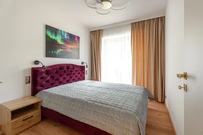 a bedroom with a purple bed and a window at Luna Et Sol Apartments in Rząska