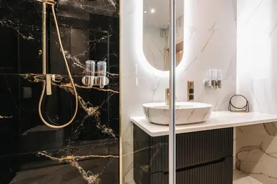a bathroom with a sink and a shower at Luna Et Sol Apartments in Rząska