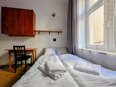 a bedroom with a bed and a desk and a window at Starowiślna 69 by Homeprime in Kraków