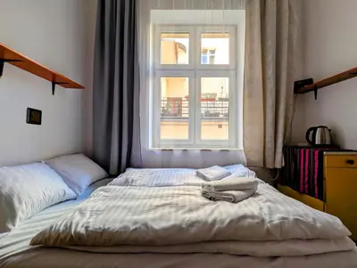 a bedroom with two beds and a window at Starowiślna 69 by Homeprime in Kraków