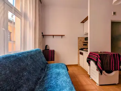 a living room with a blue couch and a window at Starowiślna 69 by Homeprime in Kraków