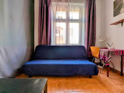 a blue bed in a room with a window at Starowiślna 69 by Homeprime in Kraków