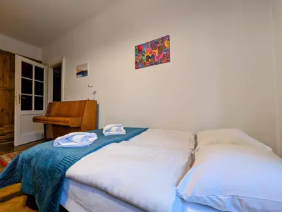 a bedroom with a bed with two towels on it at Starowiślna 69 by Homeprime in Kraków
