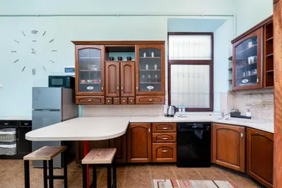 a building with a wooden door and a tree on a sidewalk at Park Strzelecki Cosy Studio by BookingHost in Kraków