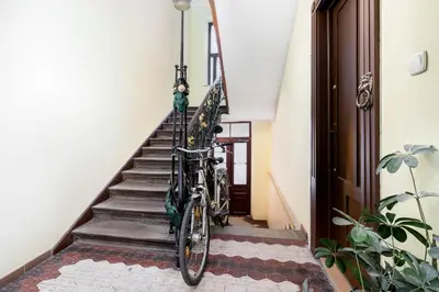 a kitchen with a refrigerator and a table and a couch at Park Strzelecki Cosy Studio by BookingHost in Kraków
