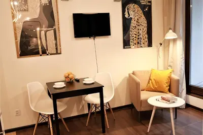 a living room with a table and chairs and a couch at Cracow Copernican Apartment #1 - Old Town in Kraków