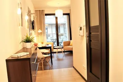 a kitchen and living room with a table and chairs at Cracow Copernican Apartment #1 - Old Town in Kraków