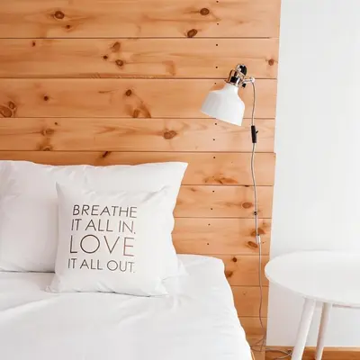 a bed with a pillow with the words breathe fall in love at Cracow Copernican Apartment #2 - Old Town in Kraków