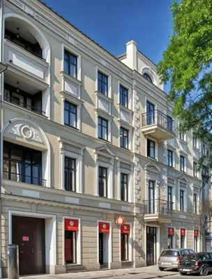 a building on a street with cars parked in front of it at Cracow Copernican Apartment #2 - Old Town in Kraków