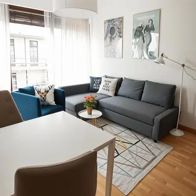 a living room with a couch and a table at Cracow Copernican Apartment #2 - Old Town in Kraków