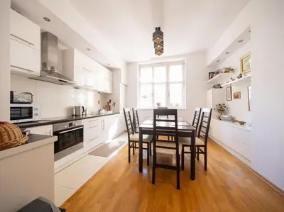 a kitchen with a dining room table and chairs at One Bedroom city center Krakow in Kraków