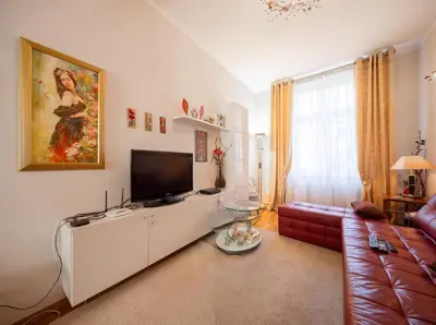 a living room with a couch and a tv at One Bedroom city center Krakow in Kraków