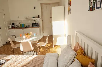 a living room with a couch and a table with chairs at Cracow Route #1 - Old Town in Kraków