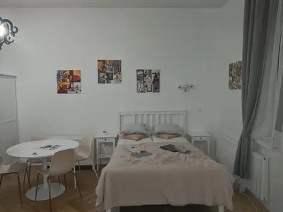 a bedroom with a bed and a table with chairs at Cracow Route #1 - Old Town in Kraków