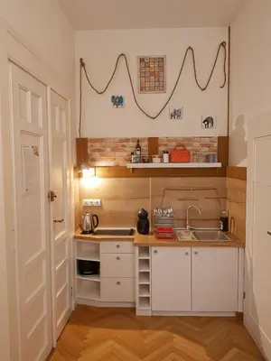 a small kitchen with white cabinets and a sink at Cracow Route #2 - Old Town in Kraków