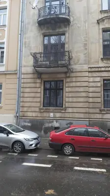 two cars parked in front of a building at Cracow Route #2 - Old Town in Kraków
