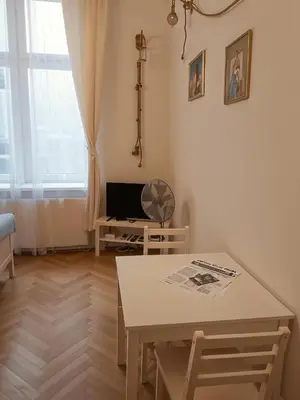 a living room with a table and a television at Cracow Route #2 - Old Town in Kraków