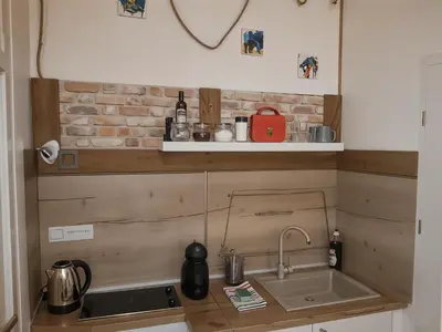 a kitchen with a sink and a brick wall at Cracow Route #2 - Old Town in Kraków