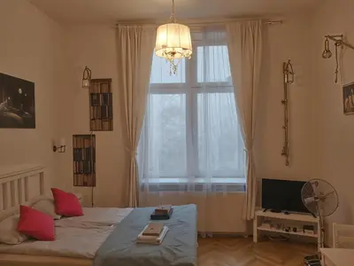 a bedroom with a bed and a large window at Cracow Route #2 - Old Town in Kraków