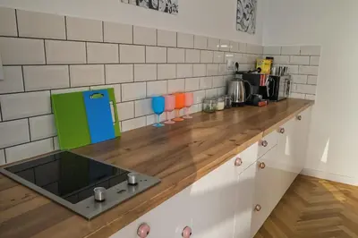 a kitchen with a wooden counter top at Cracow Route #3 - Old Town in Kraków