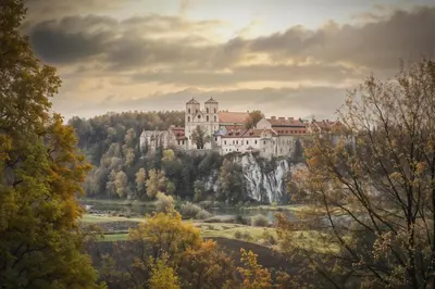 a castle on top of a hill with trees at Cracow Route #4 - Old Town in Kraków
