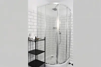 a bathroom with a shower with a glass door at Cracow Route #4 - Old Town in Kraków