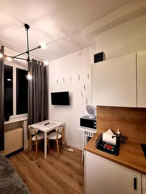 a small kitchen with a table and a small room at Cracow Vistula Boulevard #1 - Old Town in Kraków